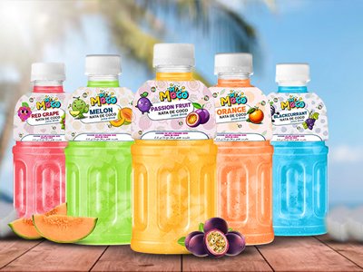 Colorful Mr. Moco juice bottles with Nata de Coco displayed on a tropical wooden table.